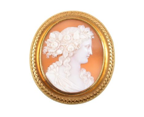 
	
		A mid Victorian shell cameo of Flora, circa 1870, the oval bullsmouth shell cameo carved with the profile of Flora, her 
