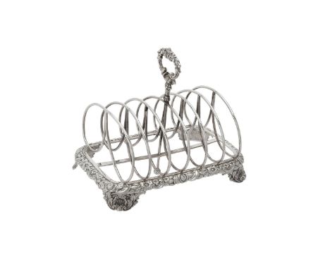 A George IV silver six division toast rack by Joseph Angell I, London 1824, with a loop handle, chased with floral and C-scro