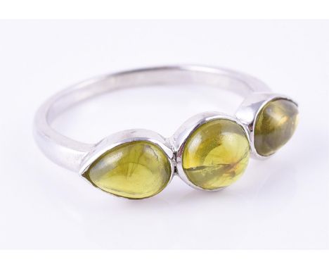 
	
		A three stone peridot ring, finger size R, 2.6g gross
		
		Condition Report: 
		The ring is unmarked, it is acid tested 