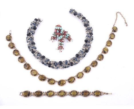 
	
		A 1960s blue paste collar necklace by Christian Dior, the rectangular pearls set with cabochon and facetted blue and gre
