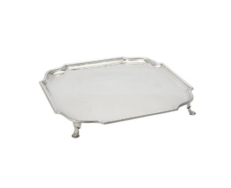 
	
		A Scottish silver shaped square salver by Hamilton &amp; Inches, Edinburgh 1928, with a raised moulded border and on fou