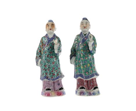 TWO EARLY 20TH CENTURY CHINESE POLYCHROME FIGURES, each modelled as a standing male with detachable left hand raised, wearing