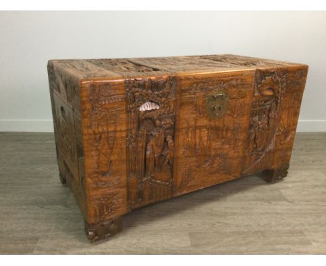 CHINESE CAMPHORWOOD BLANKET CHEST, the hinged rectangular top, front and sides carved in relief with figures and landscape sc