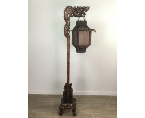 CHINESE CARVED WOOD FLOOR STANDING LAMP, modelled in the form of a dragon, with a fabric lantern type shade suspended from it