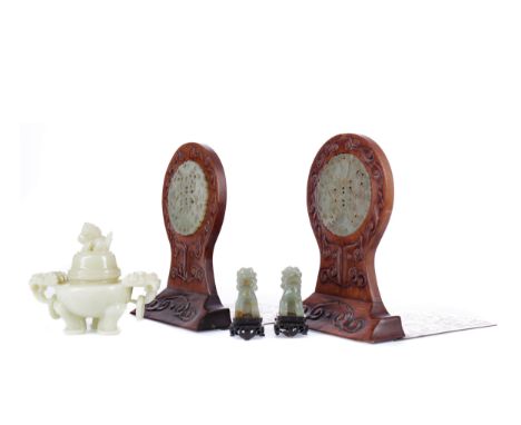 PAIR OF 20TH CENTURY CHINESE BOOKENDS, each of carved wood and inset with a circular hardstone, with a brass base, 17.5cm hig