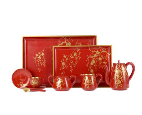 20TH CENTURY JAPANESE LACQUERED TEA SERVICE IN FITTED CASE, painted with blossoming branches in gold lacquer on a rust red gr