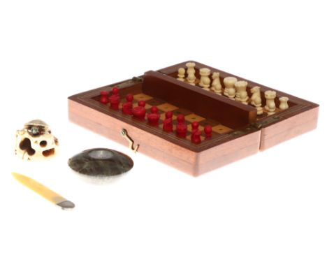 An Ivory Netsuke, in the form of a climbing tortoise, a bone travel chess set with white and red stained pieces, and a serpen