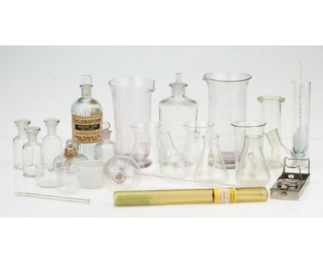 A Small Group of Chemist's Glass Laboratory Equipment, including amethyst glass measures, thistle jugs, Chloroform bottle, hy