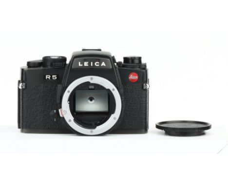 A Leica R5 SLR Body, black, serial no. 1900130, shutter working on manual mode, otherwise untested
