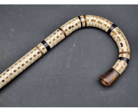 A horn and vertebrae walking stick, 90cm long.&nbsp;&nbsp; 