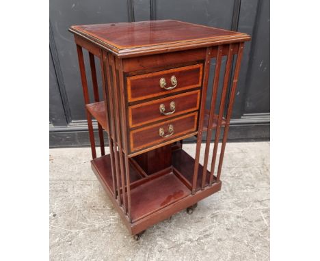 A late Victorian mahogany, satinwood crossbanded and line inlaid revolving bookcase,&nbsp;with three small drawers, 48cm wide