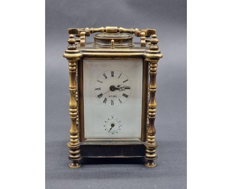 A brass carriage clock,&nbsp;with alarm and push button repeat, height including handle 21cm. 