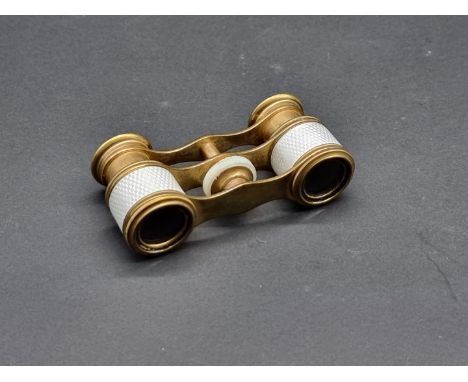 A pair of gilt brass and guilloche enamel opera glasses, with mother-of-pearl adjustment ring,&nbsp;9cm wide. 