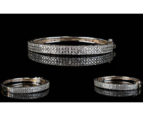 Silver Cluster Bangle. Contemporary clasp bangle set with three rows of faceted crystals