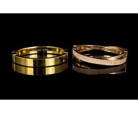 Two Michael Kors Bangles. The first in rose gold tone metal, of criss cross form set with crystal chips. The second, a contem