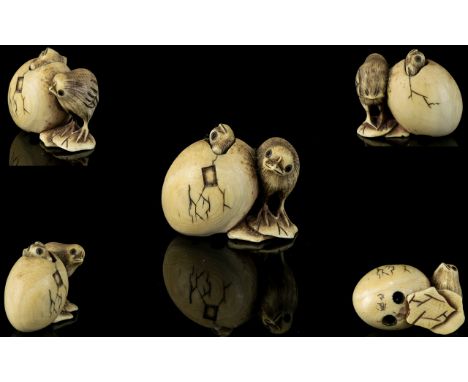 Japanese- Mid  19th Century Fine Quality And Signed Carved Ivory Netsuke in the form of a chick standing next to a moveable c