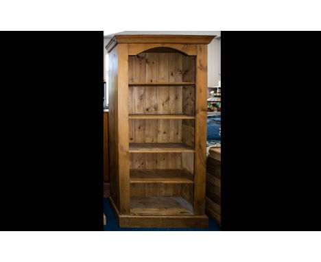 A Solid Pitched Pine Bookcase Large four shelf bookcase of traditional form, with cornice detail and rustic patina. Height 72