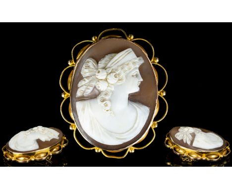 9ct Gold Mounted Shell Cameo Brooch with attached 9ct gold safety chain. Marked 9ct. Depicts portrait of a classical Roman ma