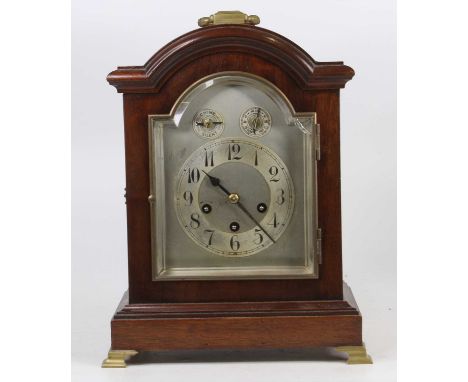 An early 20th century mahogany cased bracket clock, having a silvered arched dial, three-train striking and chiming musical m
