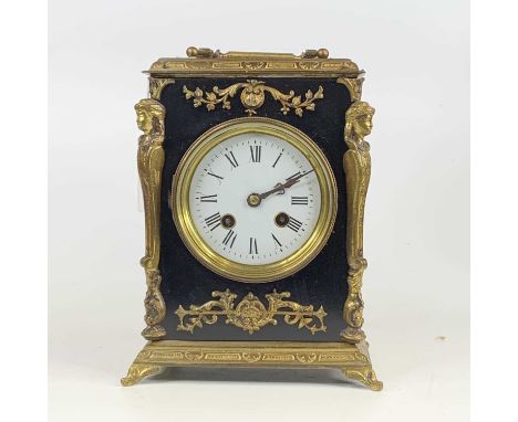 A circa 1900 gilt brass and ebonised mantel clock having unsigned white enamel dial and with brass cylinder movement striking