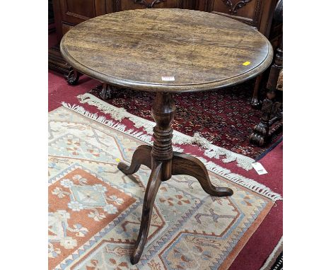 A contemporary oak circular tilt-top pedestal tripod table, on hipped supports, dia.62cm 