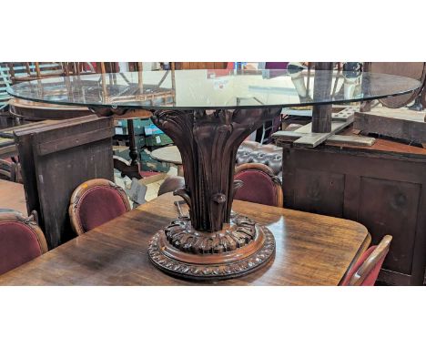 A contemporary heavy glass oval topped and acanthus leaf floral carved cherrywood based pedestal centre table, length 144cmGl