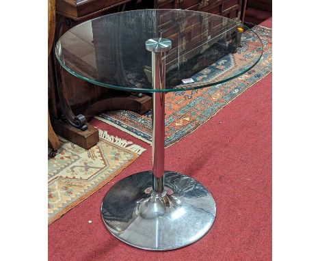 A contemporary glass topped and chromed metal based circular cafe table, dia.70cm 