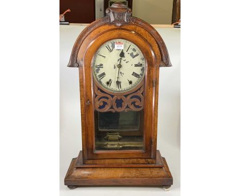 A late 19th century American walnut cased mantel clock, having an unsigned white enamel dial (badly flaking), h.70cm