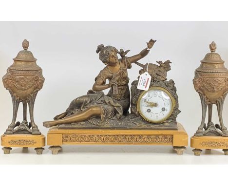 An early 20th century bronzed spelter and marble three-piece clock garniture, the clock as a seated young musician and having