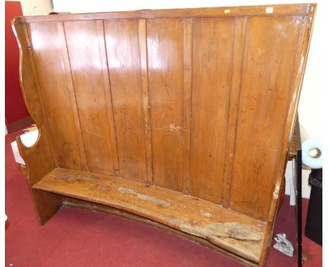 A 19th century elm curved bench settle, with six panel raised back, pronounced profile end arm supports, height 174cm, width 