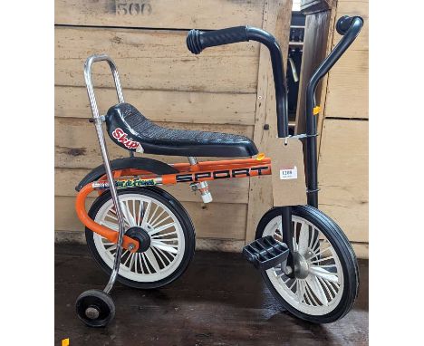 A 1970s children's vintage tricycle, with rear stabliser wheels