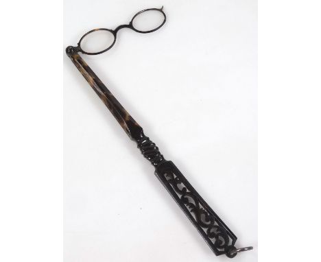 An early 20thC spring loaded lorgnette, in tortoiseshell style plastic case with ring top, (when closed) 27cm wide.