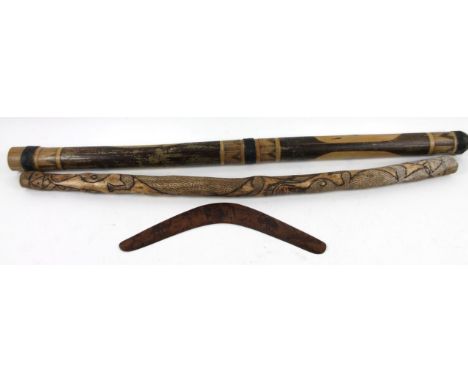 Various Australian artifacts, comprising of two didgeridoo and a pokerwork decorated boomerang, 45cm wide.  (3)