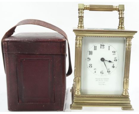 An early 20thC Goldsmiths company carriage clock, the swing handle raised above a 6cm wide back plate, with Arabic dial, mark
