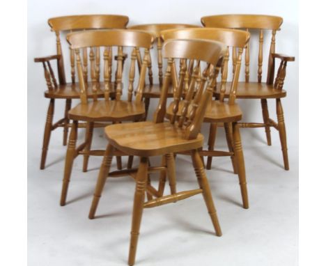 A set of six (4+2) light beech dining chairs, each with baluster backs, shaped seats, ring turned supports joined by H stretc
