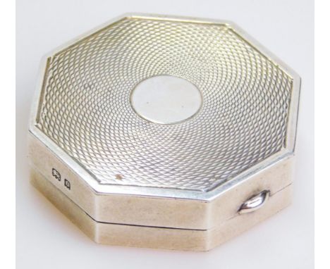 A George V silver patch box, of octagonal outline, partially engine turned with a (vacant) cartouche, partial mirrored interi