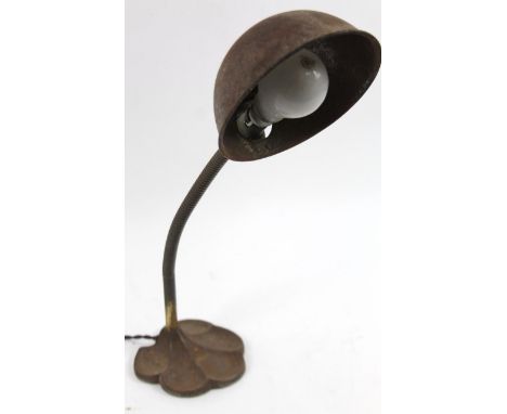An early 20thC industrial Bauhaus style angle poise lamp, with half circular shade, turned stem and shell base, 48cm high.