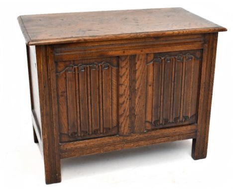 A 1920s linenfold carved oak coffer of small proportions, with hinged top on stile feet, height 52cm, width 68cm, depth 37cm.