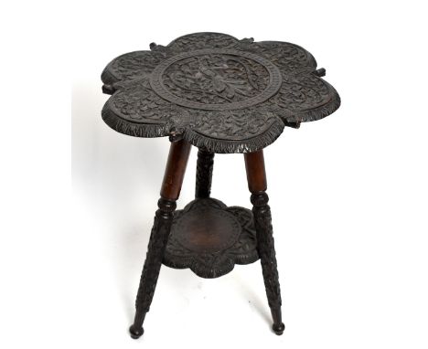 An Anglo-Indian carved hardwood occasional table, the top decorated with a deity and animals on tripod base, height 52cm, dia