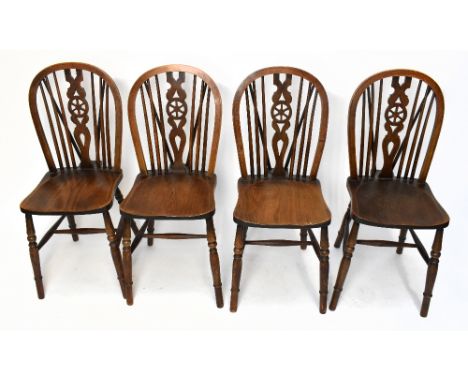 A set of four early 20th century beech and ash wheel back country kitchen chairs, with solid seats and turned legs, height 88