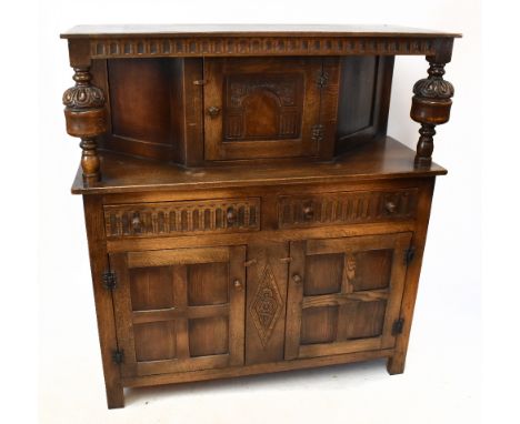 A 17th century style carved oak court cupboard, with panelled door above two drawers and two cupboard doors, on stile feet, h