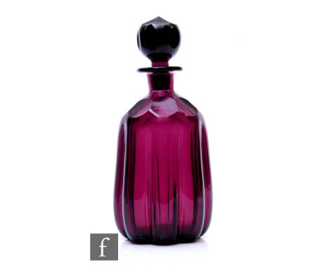 A late 19th to early 20th Century glass decanter, of shouldered cylinder form with deep ribbing and facet cut shoulders, belo