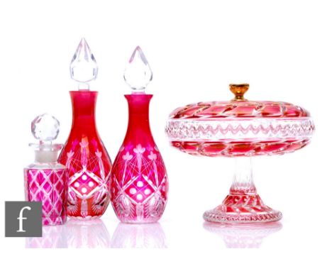 A near pair of 19th Century Bohemian perfume bottles, of ovoid form with flared neck, the body cased in ruby and flash cut wi