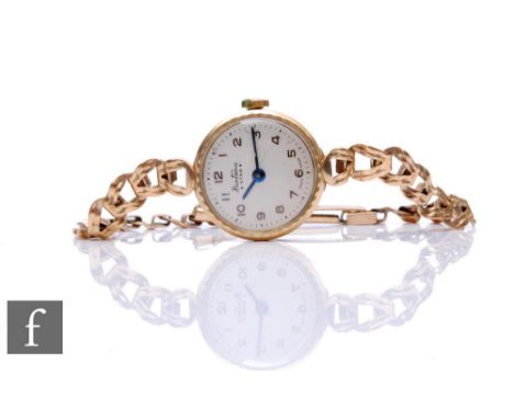 A lady's 9ct hallmarked Bentima manual wind wrist watch, Arabic numerals to a silvered dial to a 9ct link bracelet, total wei