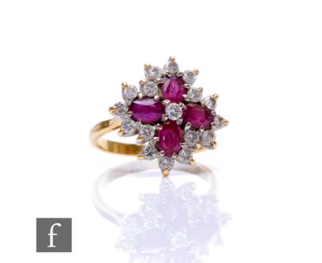 An 18ct hallmarked ruby and diamond cluster ring, four oval rubies within a sixteen stone brilliant cut diamond border, weigh