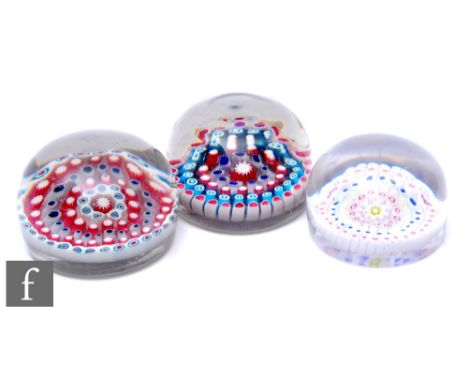 An Old English glass paperweight, of high domed form, internally decorated with a central complex cog cane surrounded by four