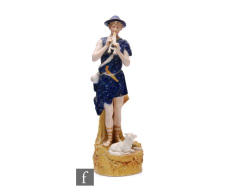 A Royal Dux figure of a shepherd, modelled standing on a rocky outcrop with a lamb at his feet and playing a pipe, pink trian