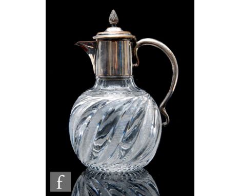 A late Victorian clear crystal claret jug, of globe and shaft form with moulded wrythen decoration and diamond cut panels, wi