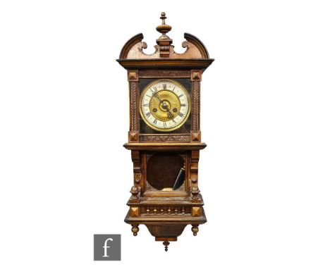 A late 19th Century walnut and part ebonised cased wall clock, spring driven eight day movement, enclosed by a glazed door ab