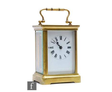 An early 20th Century French lacquered brass and bevelled glass cased carriage clock by Duverdry &amp; Bloquel, the white ena